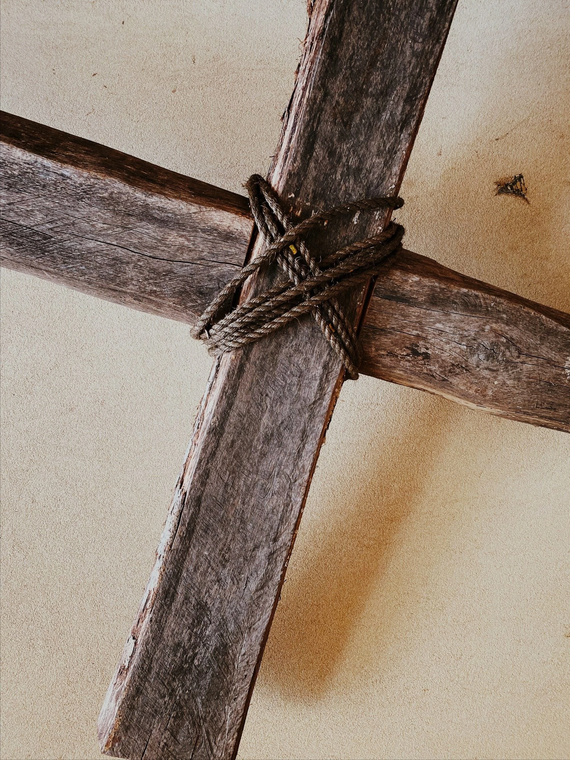 A cross with rope wrapped in the middle